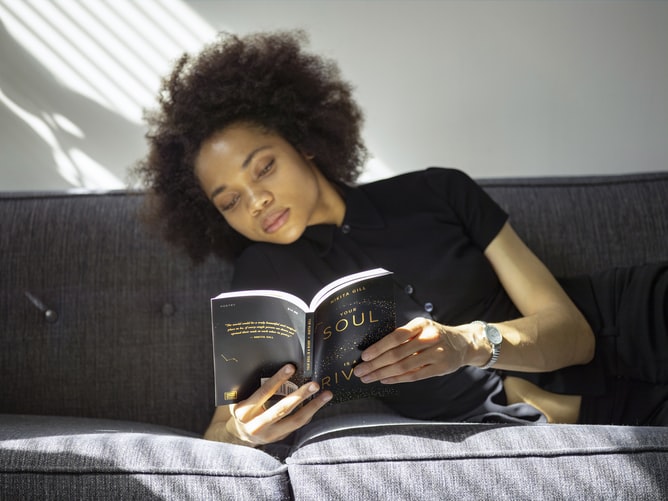 African American woman reading a book